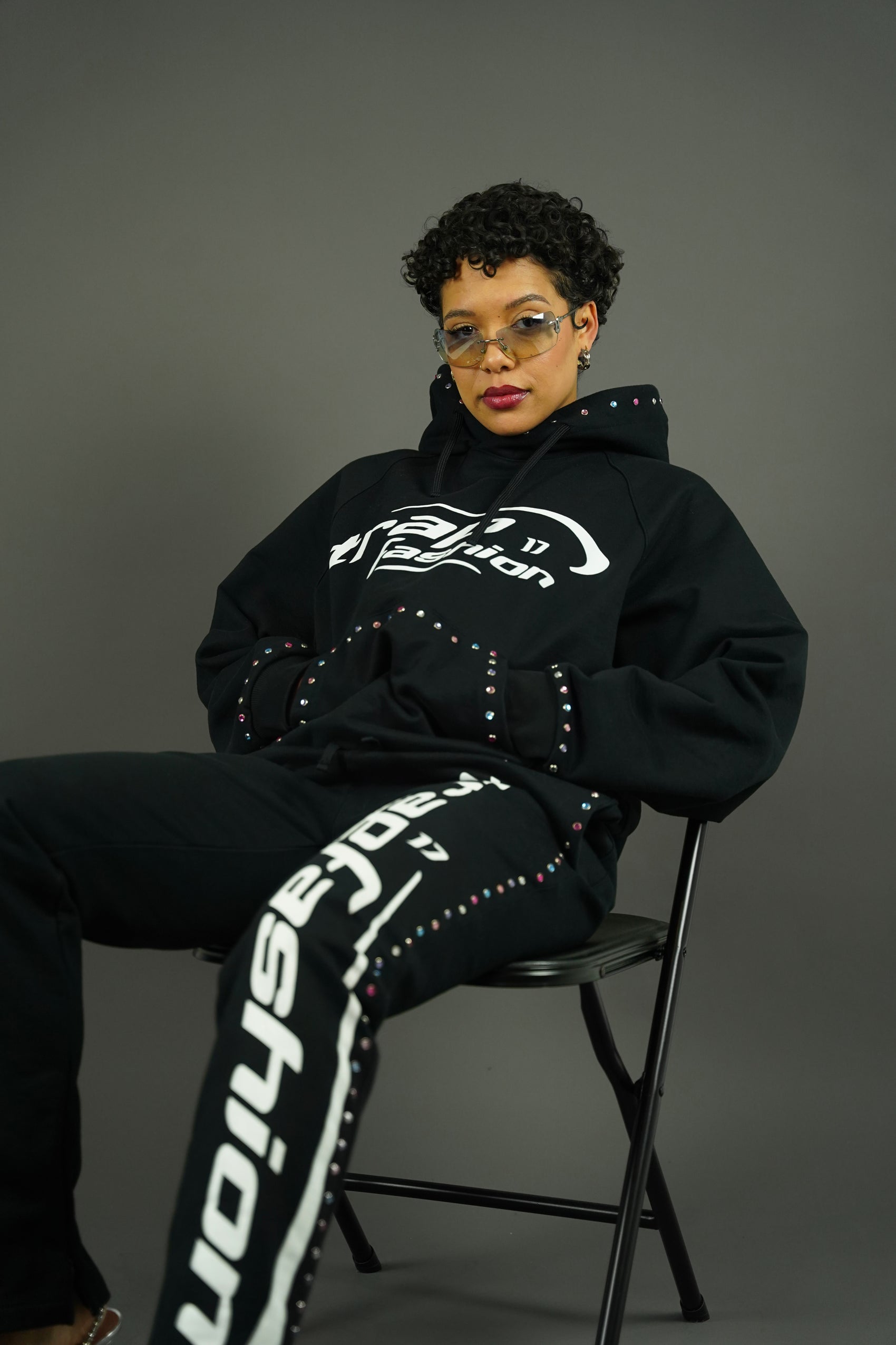 Model sitting with Trapfashion Diamond studded Hoodie